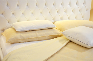 Yellow bed sheets and four pillows