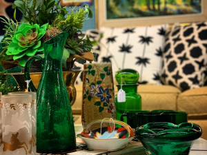 Table top with green vases and glass peices