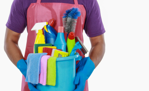 A person holding a bucket of cleaning supplies