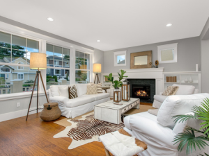 A living room with grey walls and white furniture