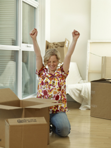 Woman sitting in her living room unpacking