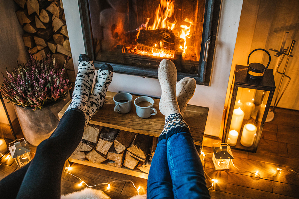 People with their feet up to a toasty fire